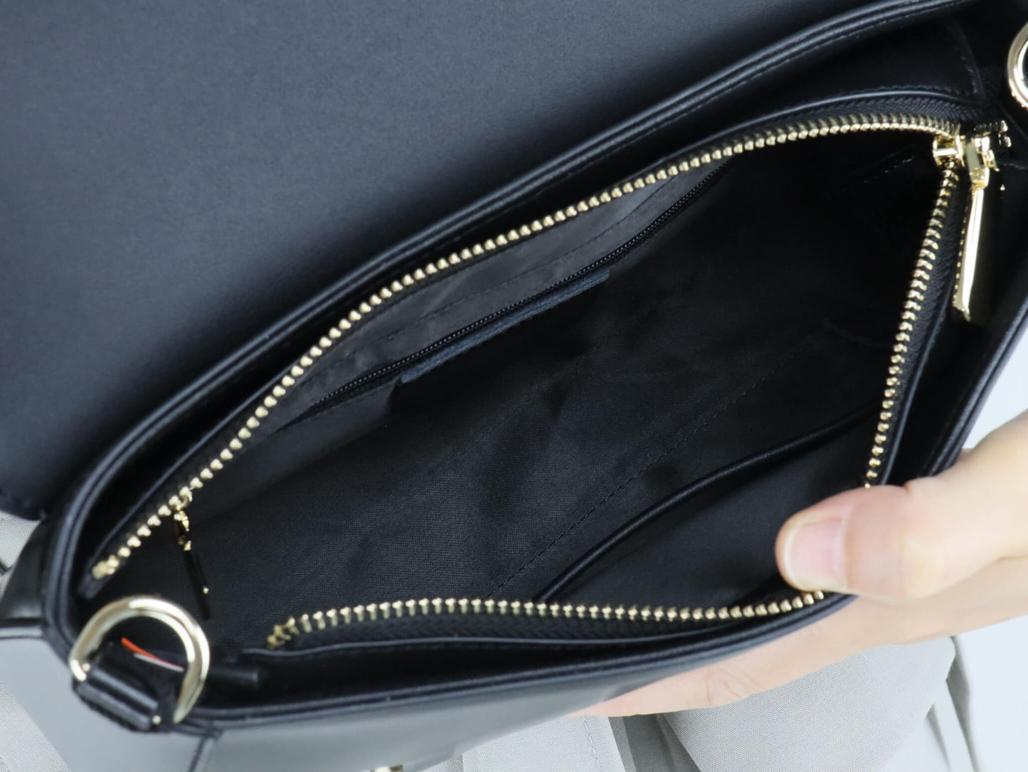a main compartment pocket, an inner pocket with a zipper, and a front pocket for cards.