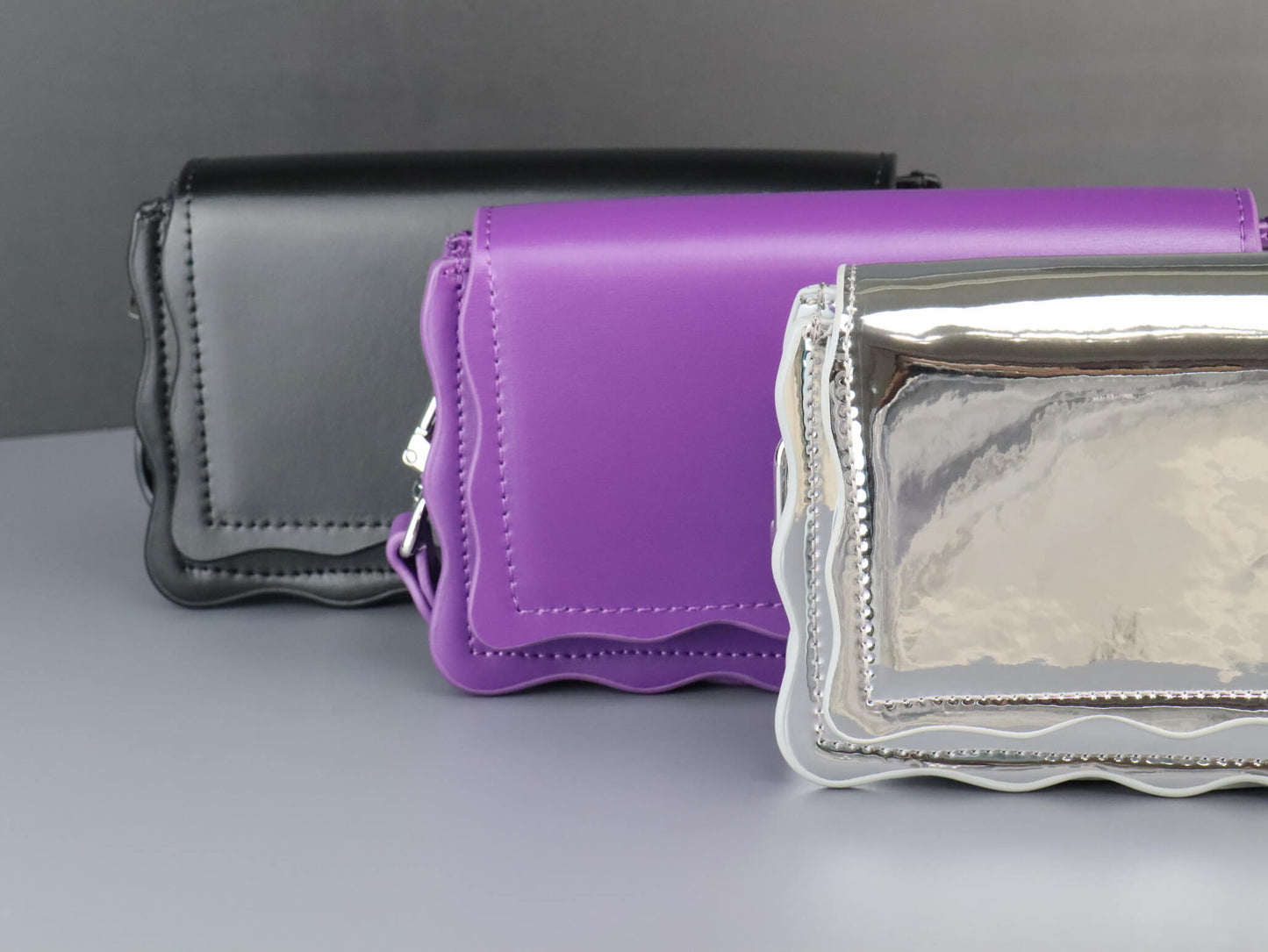 black, purple and silver leather handbag